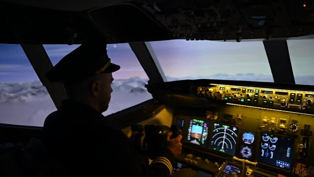 A man is studying to be a pilot in an aircraft simulator. 
