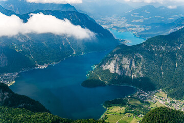 Beautiful Alps view from Dachstein Mountain with 5 Fingers viewing Platform. Majestic view of Hallstatt Lake, wild nature and clouds in Obertraun, Austria. Famous tourist observation for hikers.