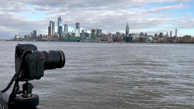 JERSEY CITY - DECEMBER 2018: Camera takes pictures of Manhattan skyline on a cloudy day