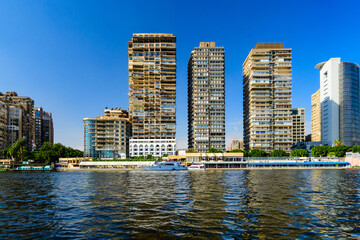 Residential and office buildings of the Cairo city. View from Nile river - obrazy, fototapety, plakaty