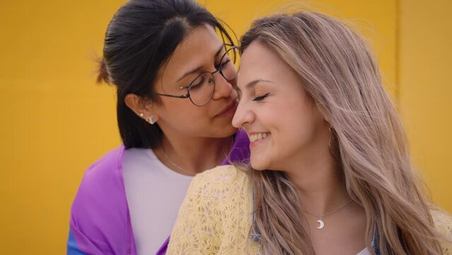 Happy Nice LGBT Young Caucasian Lesbian Couple Together Kissing For Video On Yellow Background. People In Loving And Romantic Attitude. Generation Z And Open Minded In Sexuality. 