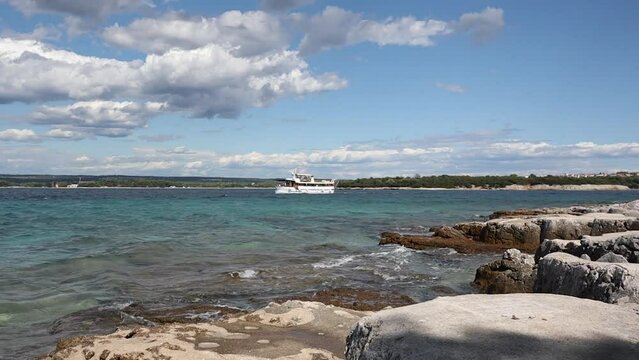 Brionian Island Shore with Boat on Adriatic Sea during Summer. Brijuni National Park with Rocky Beach during Sunny Day.