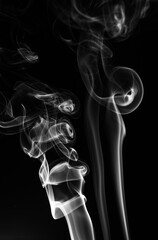 movement of smoke on black background, smoke background, abstract smoke on black background. Aromatic smoke coming out from Dhoop Cone