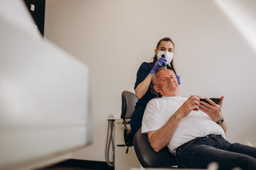 Senior man is being examined by a trichologist. Hair care concept