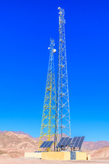 Telecommunication tower with the antennas and solar panels in a Sinai desert, Egypt