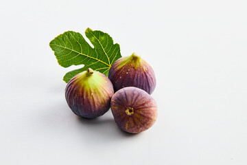 three fresh figs on a white background