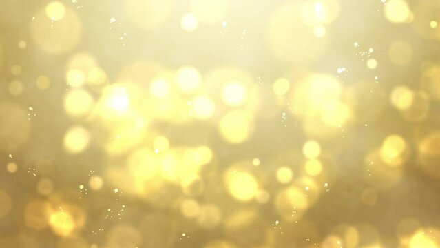 abstract gold motion backgrounds. bokeh glitter particles golden awards on gold background.
