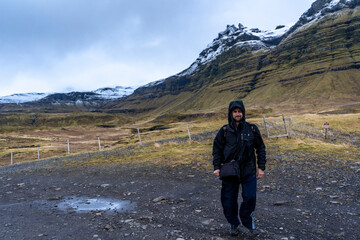 man of with freezing face in winter outwear during winter in icelandic mountains