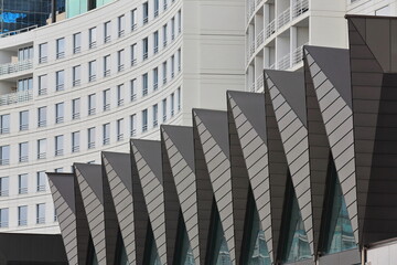 White facades and pointed roofs of modern buildings facing Darling Harbour-Wheat Road....