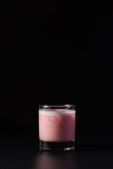Winter cherry cocktail isolated on a black studio background