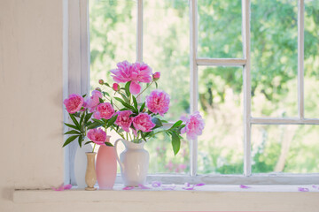 pink peony in vase on grunge white interior