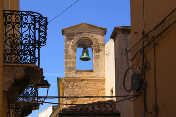 The bell tower from the church Sant Antonio Abate in a narrow alley at Castello dei Doria (Castle...