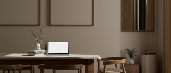 Laptop mockup and accessories on a dining table in minimal Scandinavian dining room.