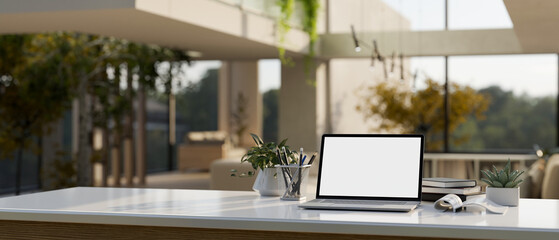 Home workspace with laptop mockup on white table in modern contemporary living room