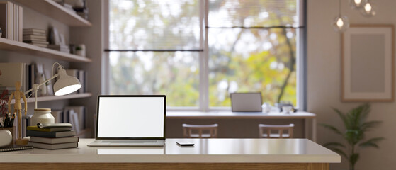 Home workspace with laptop mockup on a table in modern contemporary room.