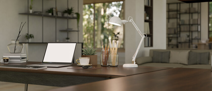 Close-up image of home workspace in modern living room with laptop mockup on a table.