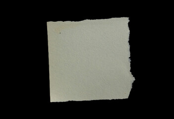 Obraz premium Ripped paper piece isolated on a black background with torn edges