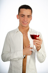 Young attractive man is drinking red wine.	