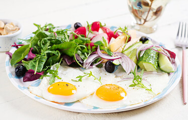 Ketogenic food. Fried egg, cheese, nuts and fresh salad. Keto, paleo breakfast.