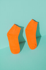 Orange socks new on the mint green background
