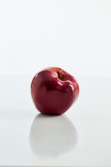 one red apple on a white background