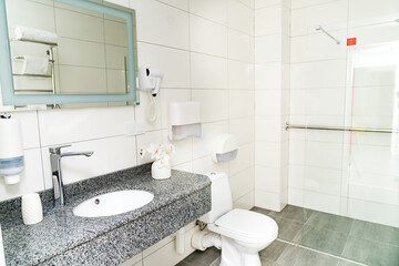 Clean light bathroom. White sink with mirror interior bathroom.