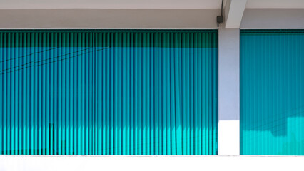 Obraz premium Blue Aluminium venetian blinds behind glass wall inside of white office building 