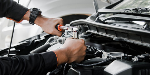 Fototapeta na wymiar Mechanic fixing a car at home. Repair and service.