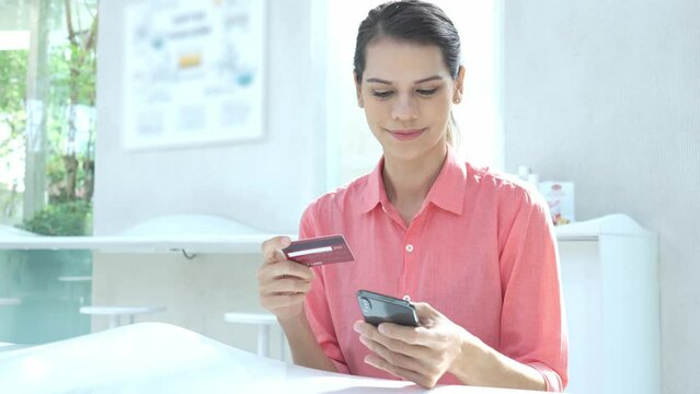 Beautiful young lady using on mobile phone online shopping in Cafes.