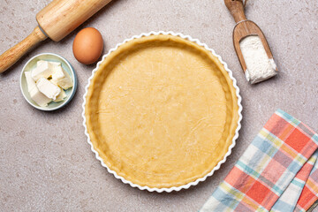 Raw, unbaked butter pie crust with ingredients for recipe, ehh, flour, butter, homemade pie dough. Top view. - obrazy, fototapety, plakaty