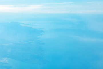 Naklejka na ściany i meble Aerial view of blue coast and blue sea