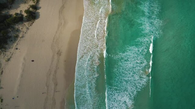 Cala Agulla near Manacor, Palma de Mallorca Island. Natural idyllic turquoise blue clear sea water, pristine sandy beach seaside cliff coast. Top view cinematic aerial drone. Spanish Balearic Majorca