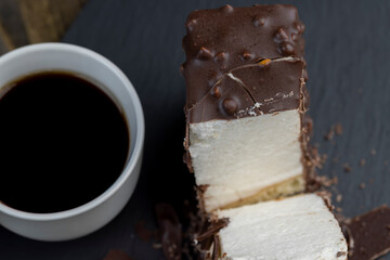 Fresh sweet cake with milk taste and aroma in chocolate glaze