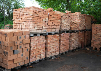 Red brick on pallets in brick factory