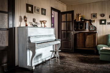 Old white piano in vintage room