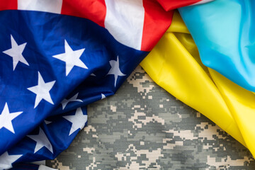 US flag together with Ukrainian flag in a single picture, flags blending one into the other.