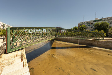 A steel pedestrian walkway painted green to save the minimum channel