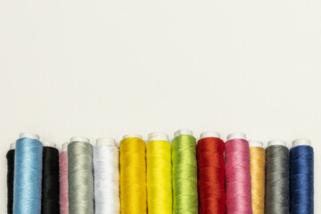 A strip of new colored reels on a plain white