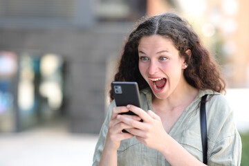 Fototapeta na wymiar Excited woman watching amazing content on phone
