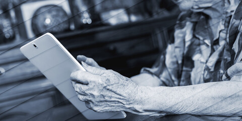 Senior woman using tablet, geometric pattern