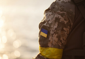 the Ukrainian flag in the form of a chevron on the hand of a military man