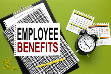 EMPLOYEE BENEFITS white paper with text on a black folder on a green background