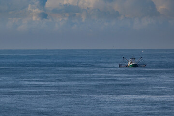 Obraz premium A cutter with lifted drag nets on the North sea