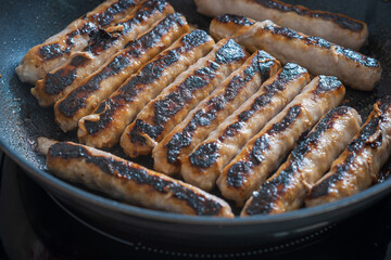 Pork sausages chipolatas pan frying