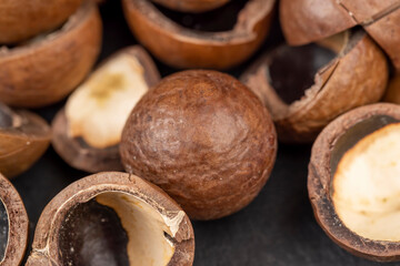 A bunch of ripe macadamia nuts in a hard shell