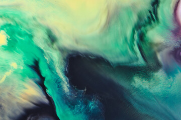 Abstract green color background. Multicolored fluid art. Waves, splashes and blots acrylic alcohol...