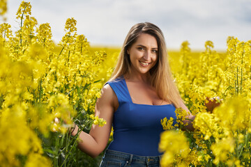 Attractive blonde latino woman in canola field