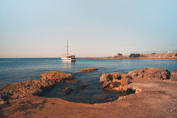 A small yacht moored off the shore