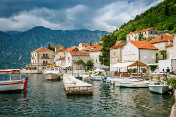 Small port with pier and boats in the historic town of Perast in Bay of Kotor