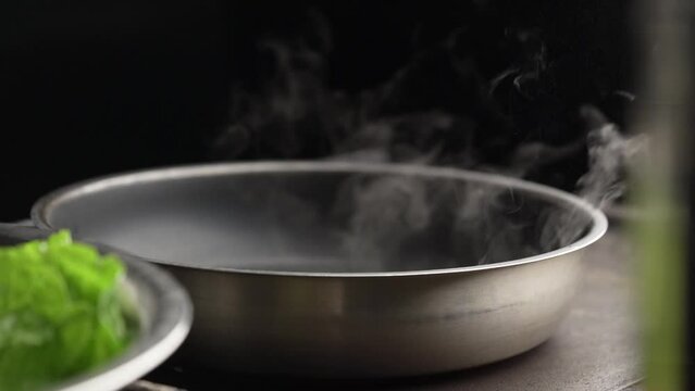 Frying pan is steaming. Coocking process